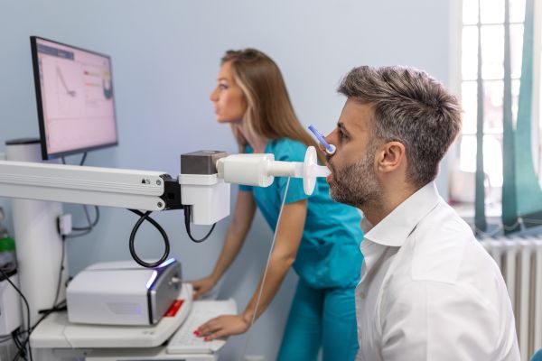 A man biting a sterile mouthpiece connected to a spirometer for a lung function test.
A man biting a sterile mouthpiece connected to a spirometer for a lung function test.


A man biting a sterile mouthpiece connected to a spirometer for a lung function test.




